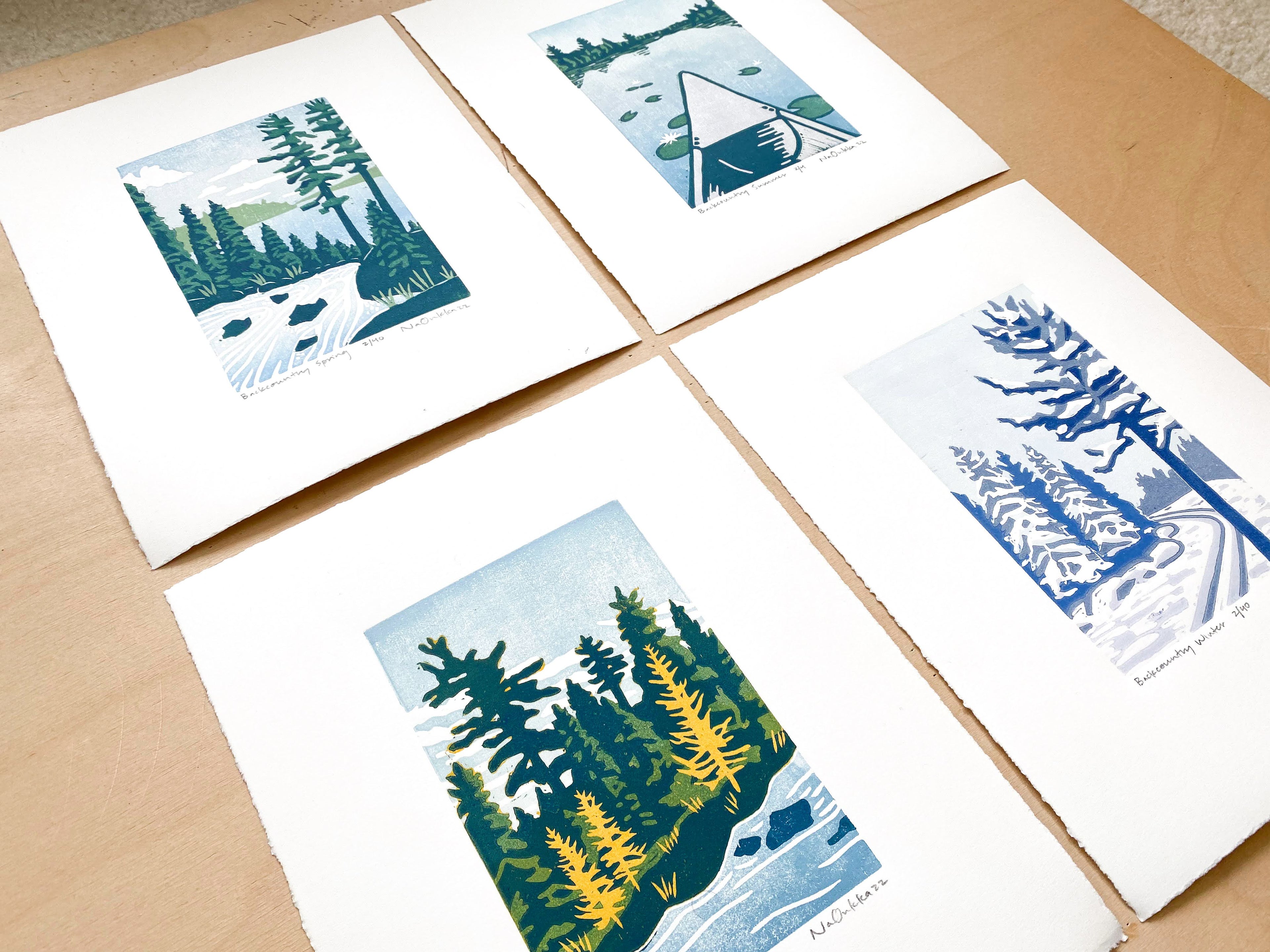 Four woodcut prints made by Nan Onkka that depict the four seasons.